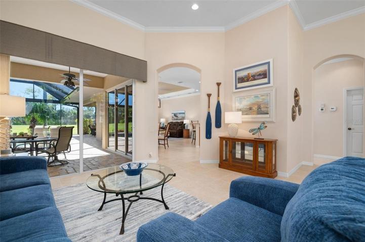 Living room with slider to lanai/pool.