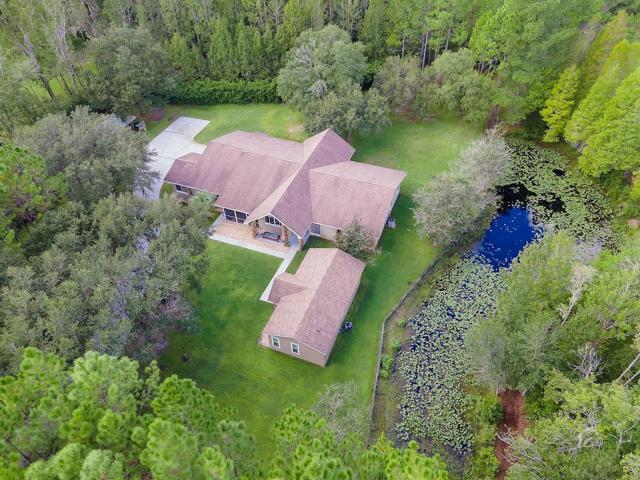 Ariel view showing main house ADU/Cottage, barn and pond