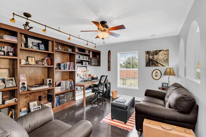 Upstairs bonus room with MORE hardwood floors.  Amazing built-in shelves and desk. Nice place to work from home!