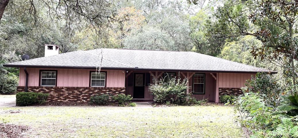 Lovely home set in "Old Florida", back from the road with large live oak trees and cedar trees in the front yard.