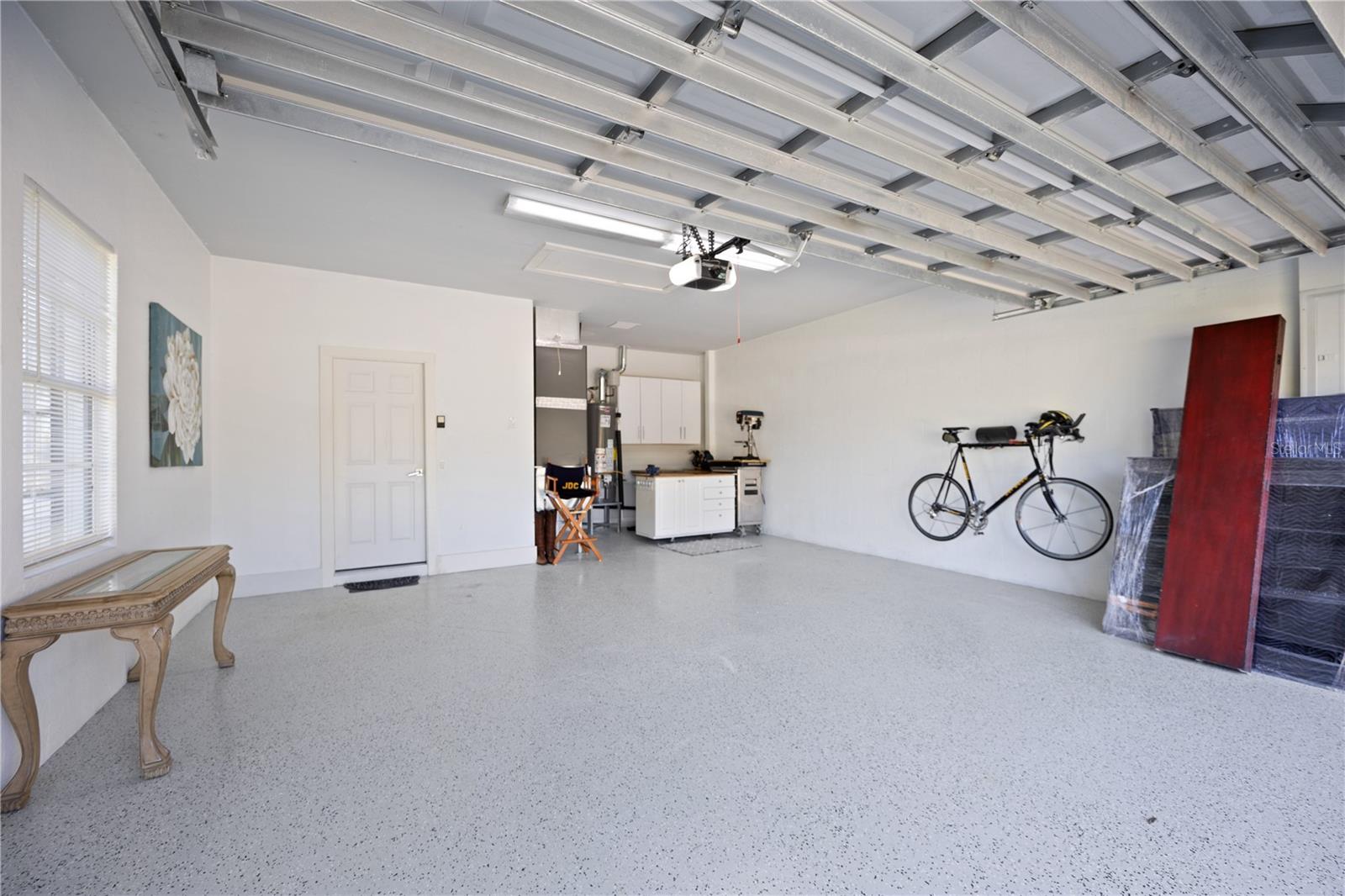 Newly paint epoxy garage floor...space for two cars and a work shop area.