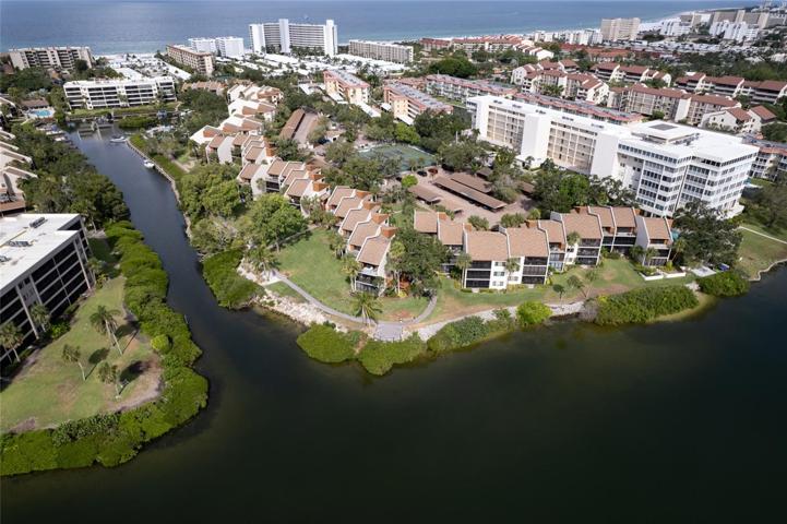 Experience the pinnacle of coastal living with this stunning condo, perfectly situated along the picturesque Intercoastal Waterway. This aerial view captures the essence of the Florida dream: a luxurious waterfront condo with deeded beach access, where modern comfort and natural beauty unite in perfect harmony.