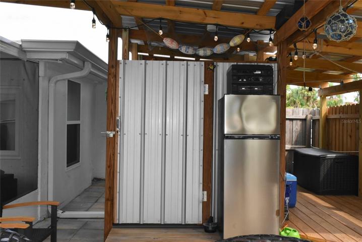 Outdoor shower and covered storage.