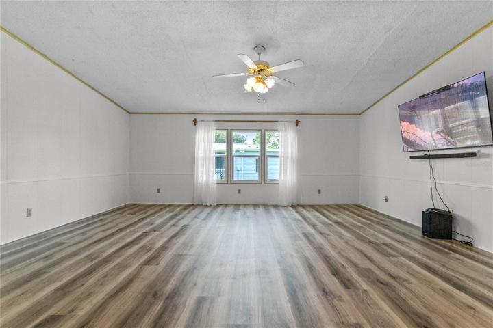 living room with mounted TV that STAYS WITH HOUSE