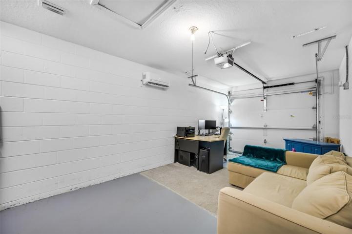 Currently used as a home office with insulated garage door and installed package air-conditioning unit