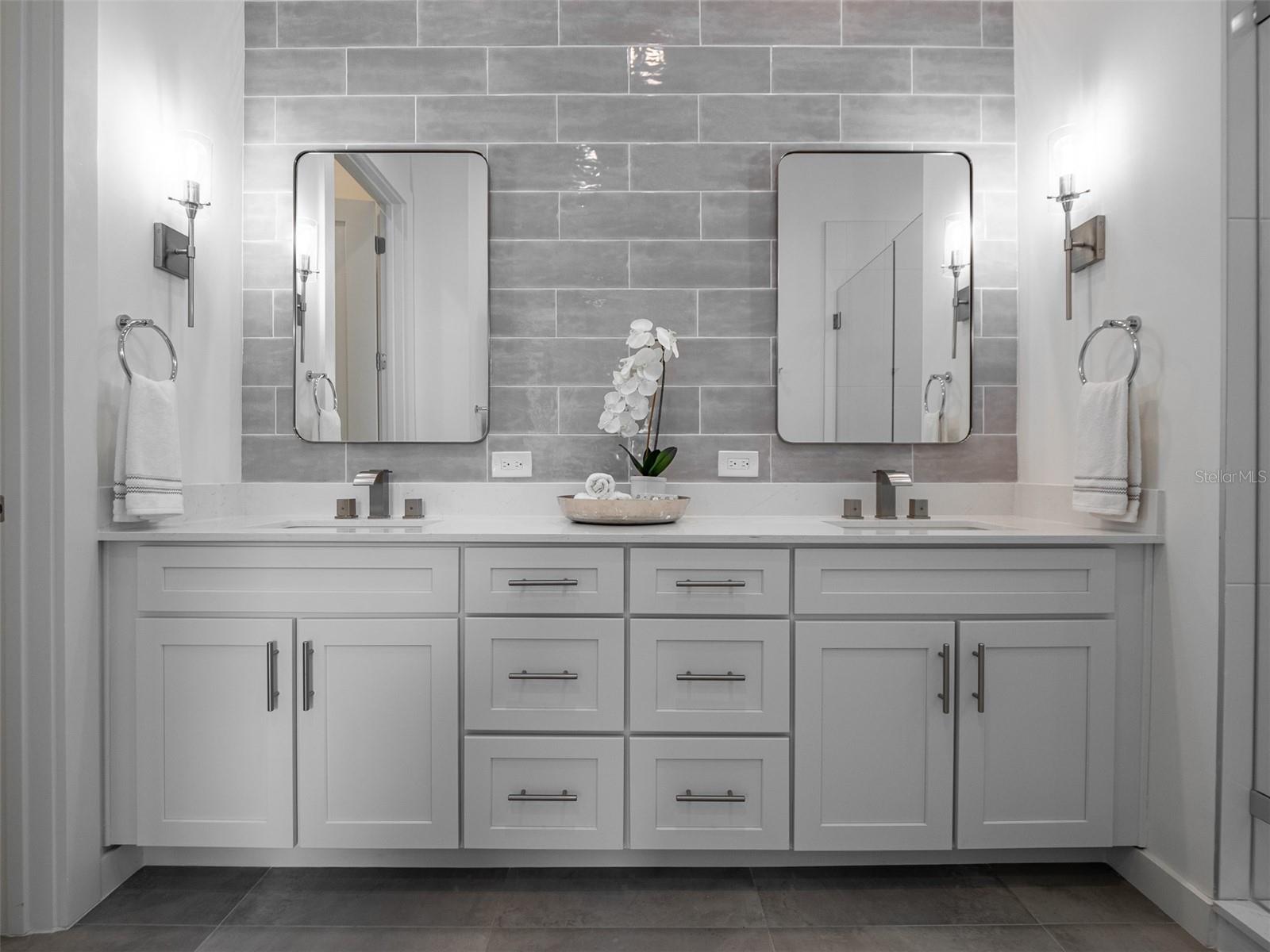 Primary suite bath with double vanities, large shower and private bidet
