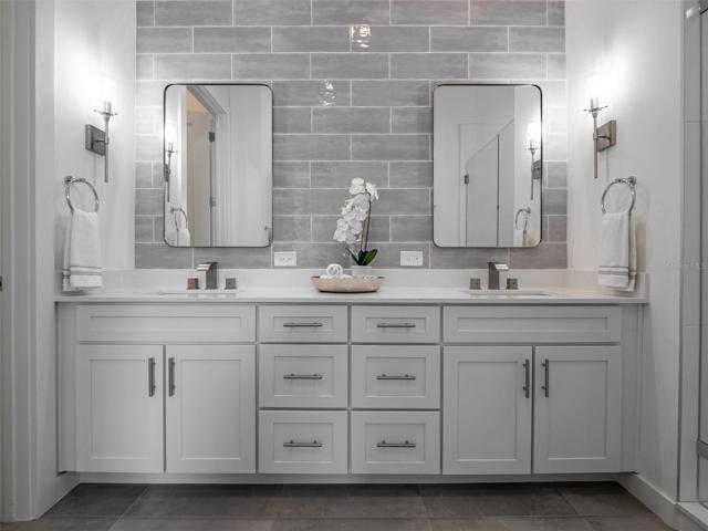 Primary suite bath with double vanities, large shower and private bidet