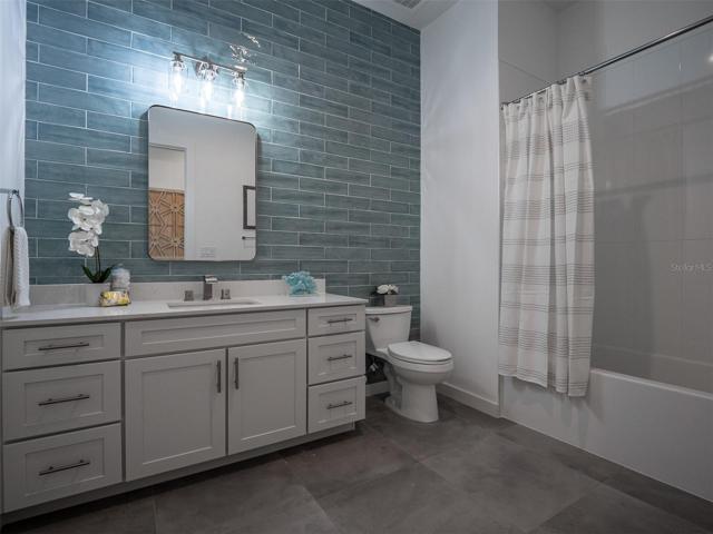 Second full bathroom with tub and shower combo