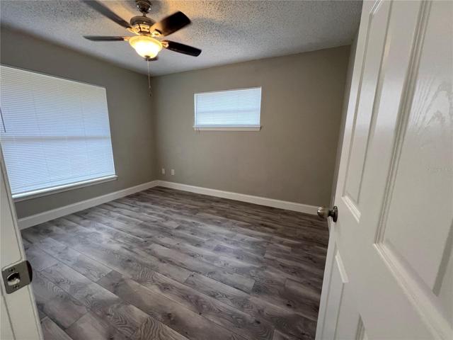 bedroom 2 featuring laminate flooring, ceiling fan