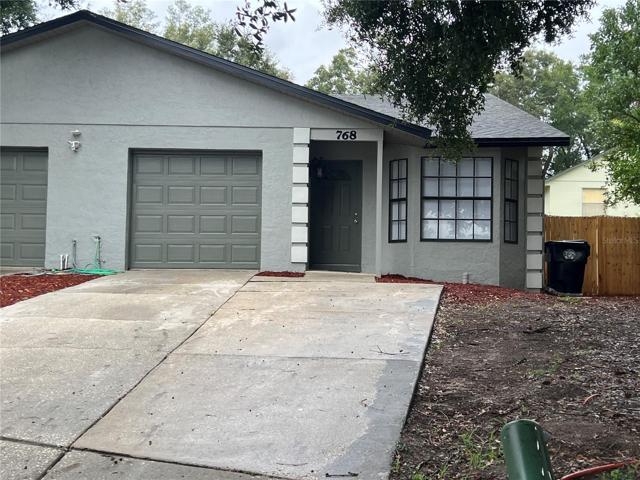 qHalf duplex freshly featuring painted exterio, brand new garage doorr and fenced back yard