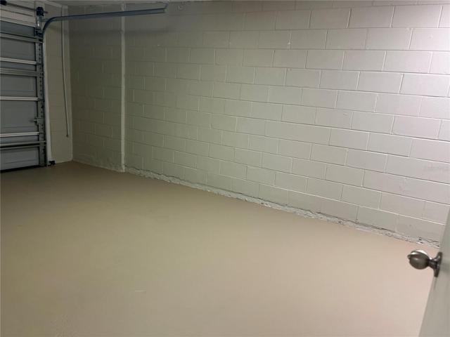 single car garage featuring brand new garage door and painted flooring