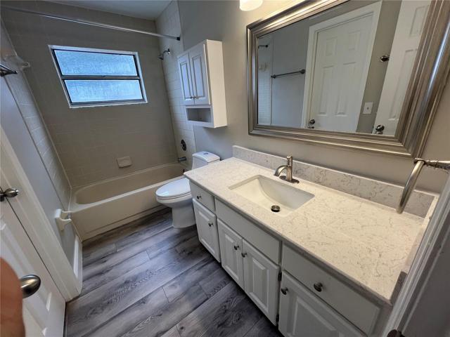 bathroom 2 featuring new cabinets,  quartz counter tops, new faucet, mirror and light fixtures