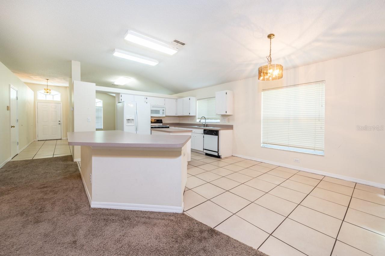 Large eat-in area is tiled for easy clean up. Notice the breakfast bar for extra seating.
