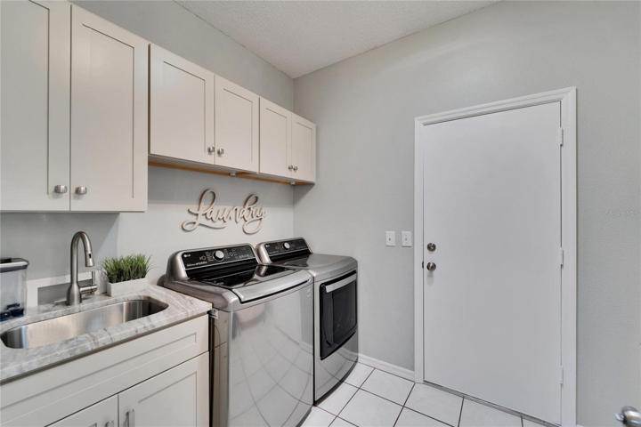 Custom built cabinets and check out the rich Granite counter top on the laundry sink.  This is not a typo, I said "Granite", in the laundry room!