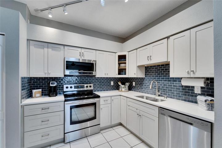Updated kitchen has Gorgeous Shaker Style Wood Cabinets.
