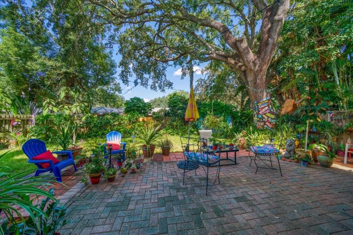 Brick patio with mature landscaping providing shade!