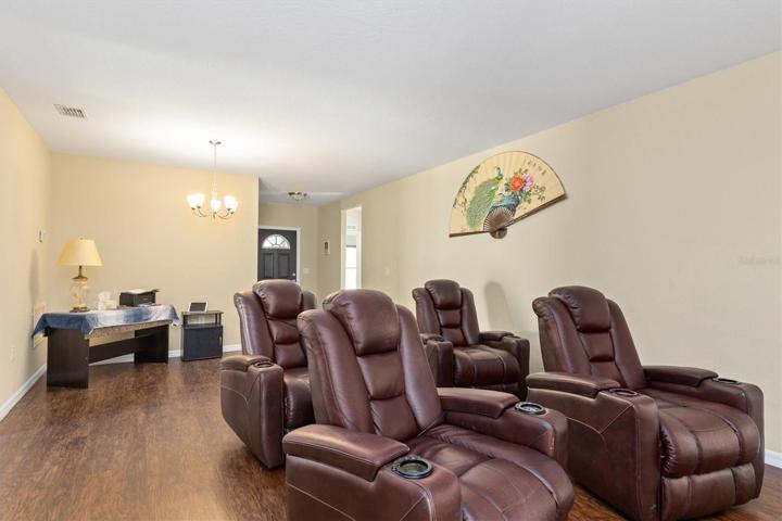 Livingroom and dining room combo.  Set up as a theater and office area