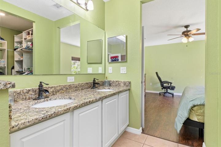 Master double vanity sink leading into master bedroom