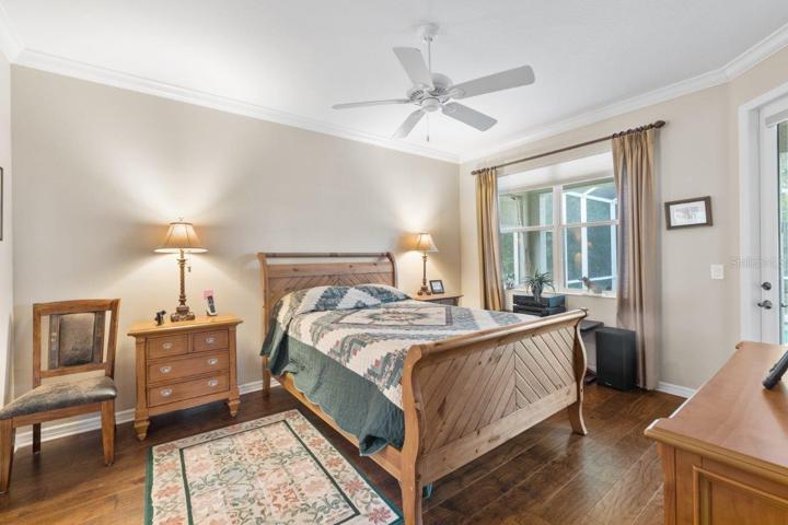 Owners suite featuring engineered hard wood, crown molding, two walk-in closets, and an ensuite bathroom.