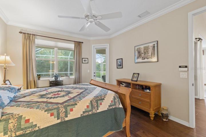 Owners suite featuring engineered hard wood, crown molding, two walk-in closets, and an ensuite bathroom.