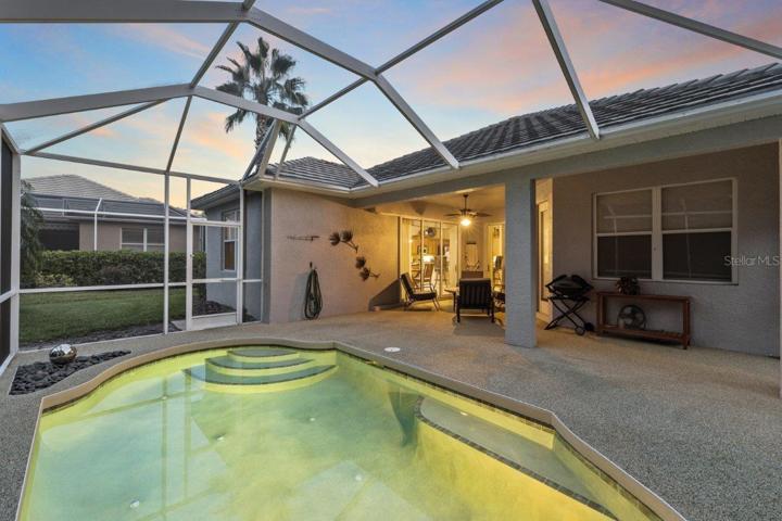 Screened-in lanai featuring a heated saltwater pool, rubber tec decking, and preserve views. NEW Pool Pump, NEW Pool Filter Canister, and New Salt Cell.