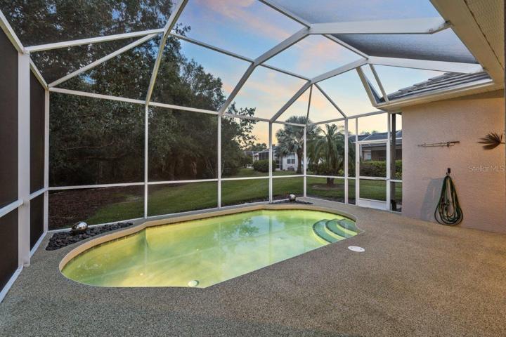 Screened-in lanai featuring a heated saltwater pool, rubber tec decking, and preserve views. NEW Pool Pump, NEW Pool Filter Canister, and New Salt Cell.