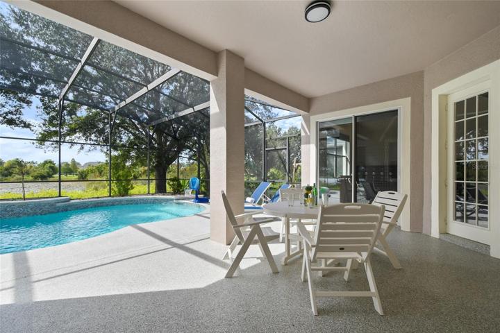 The covered lanai has access from the living room and flex room and has a wonderful water view.