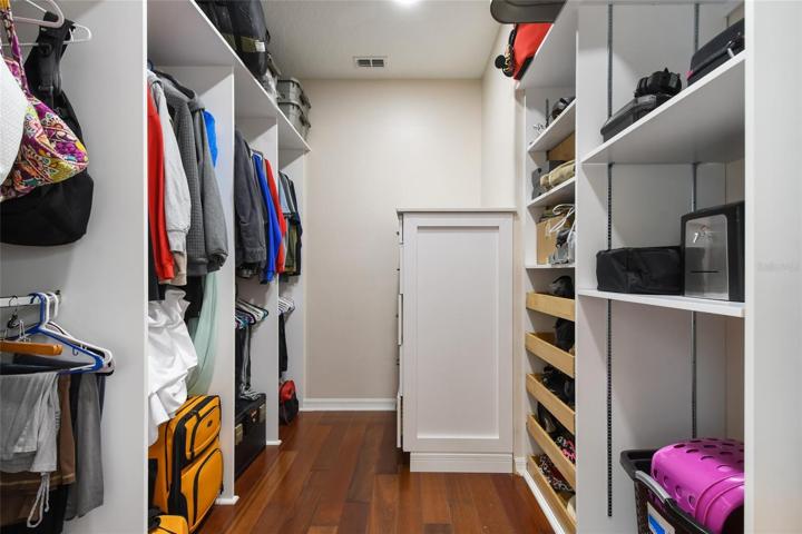 Every owners dream a fully customized walk in master closet, pull out drawers for easy access, plenty of hanging space, suitcase storage and dresser for folded garments also acts as a packing station.
