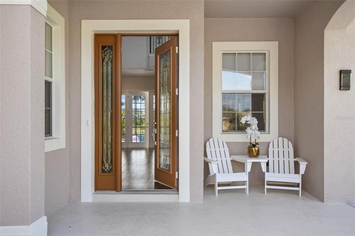 Relax on your covered front porch after a tour of the mature tree lined streets of Summerport.