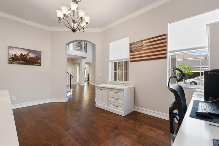 Note the crown molding and the gorgeous engineered wood flooring throughout the entire first floor, flowing seamlessly.