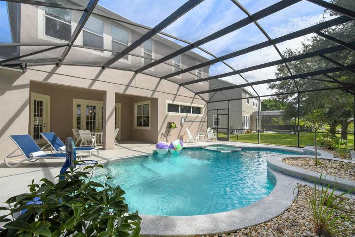Expansive pool surround allows for plenty of lounge chairs, seating and vegetation in the planting beds.
