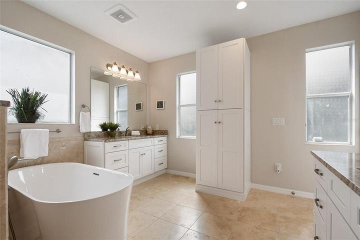 The natural color combination of neutral walls, natural tile and soft classic designer elements make this a welcome space for the owners retreat to soak, shower or freshen up after a long day.