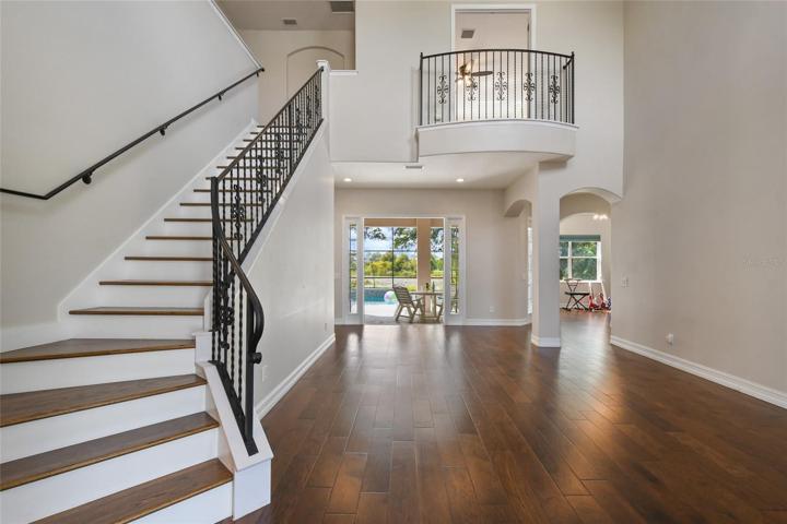 Ascend the renovated staircase finished with real wood treads, accented by wrought iron handrail and balusters while accented with stone.