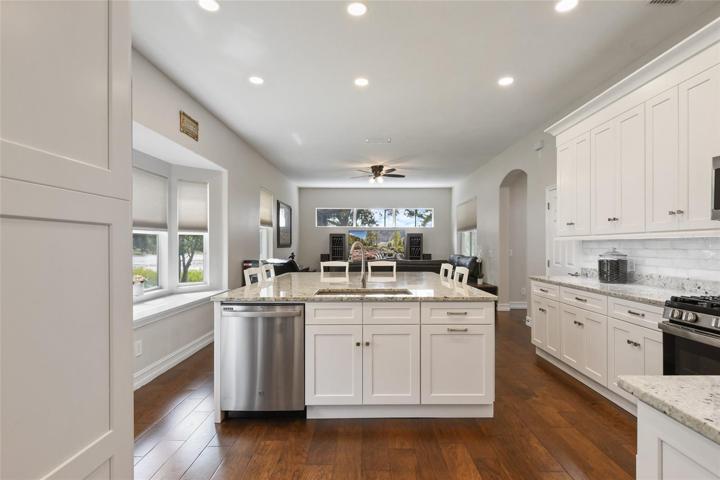 The wow factor is in place with ample space for cooking, entertaining and enjoying movie night where everyone is together. Note the bay window with view of the water.
