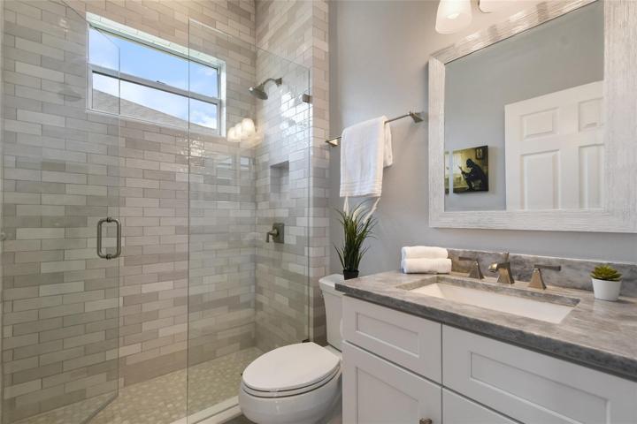 Downstairs full bathroom adjacent to the flex room for guests and use as a pool bath.