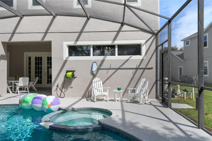 Ample room for and outdoor kitchen or grill if you chose to add. easy access to hose for pool filling and screen doors on BOTH sides of enclosure for easy access to back yard and pool equipment.
