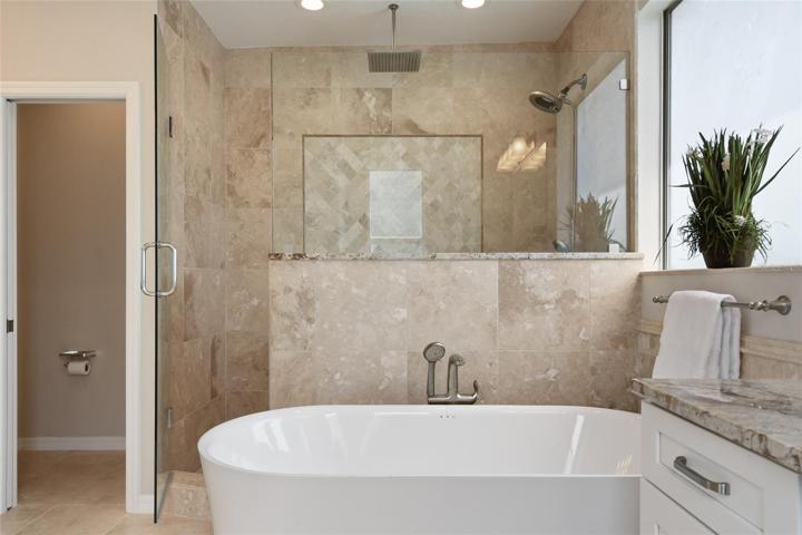 Super shower is complimented with frameless shower glass and designer tile accents.