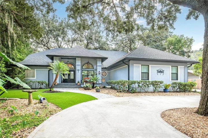 Circle drive at the front alongside a driveway leading to the garage and the back yard