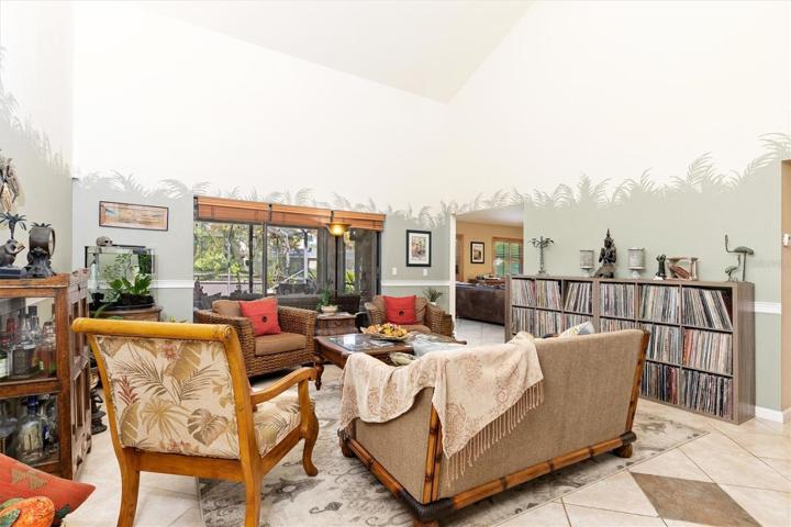 The great room under a tall vaulted ceiling. Leads into family room.