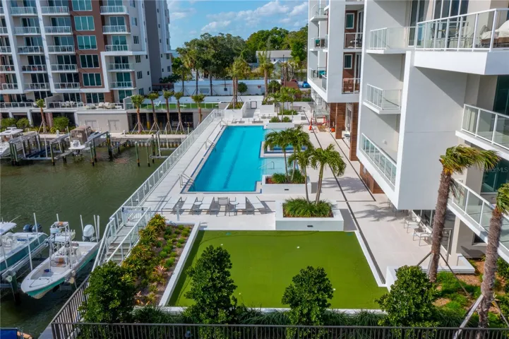 Aerial views of the putting green, pool and outdoor recreation areas with BBQ grills and outdoor dining