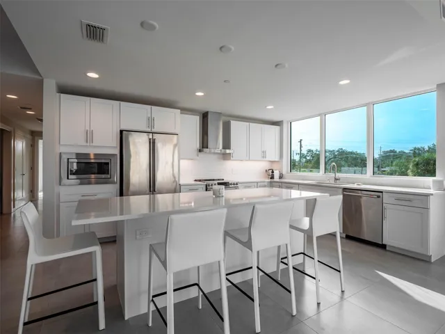 Bright and flooded with natural light open concept kitchen with spacious  breakfast bar
