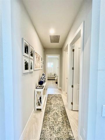 Hallway by front door leading to 3rd bedroom.