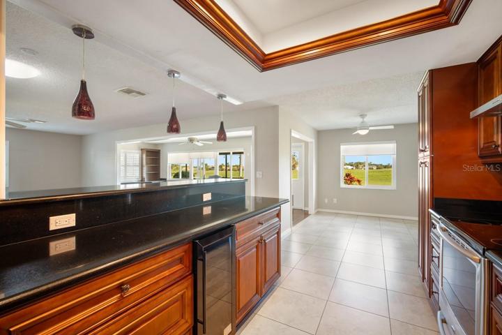 Stone counters and stainless appliances anchor the sleek kitchen