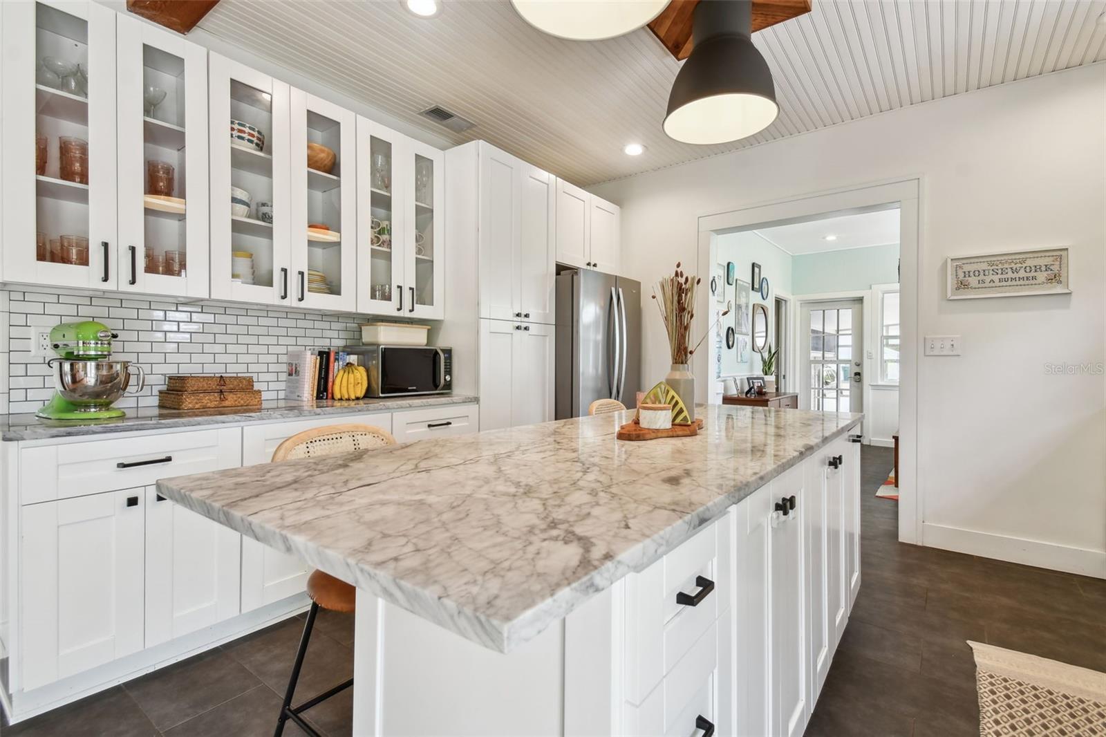 Decorator touches throughout. Glass-insert cabinets, designer hardware and lighting fixtures. Wainscoted ceiling with recessed lights.