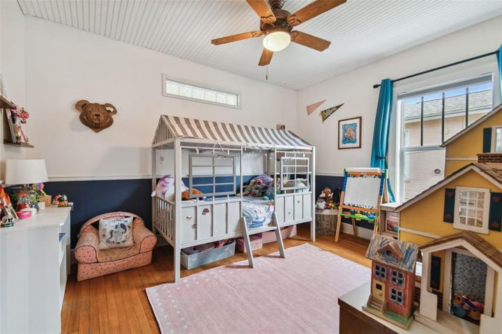 Bedroom two. Complete with chair rail and original wood floors.