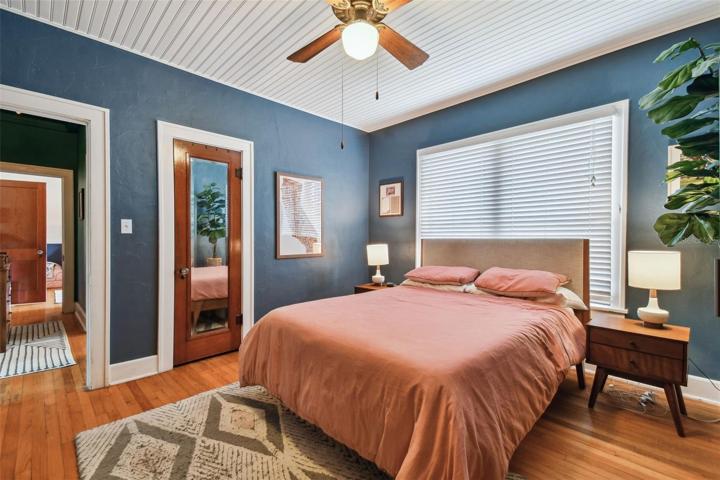 Master bedroom. Original wood floors and wainscoted ceiling.