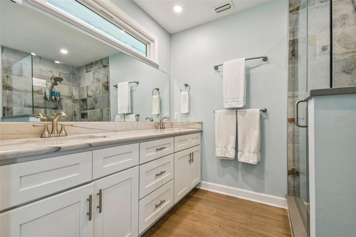 Primary bath with dual vanity, walk-in shower and modern updates