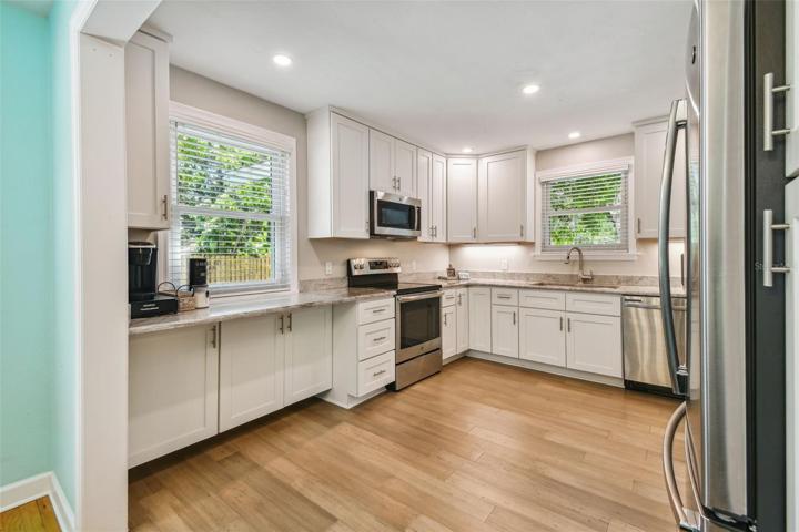 Light, light and more natural light. Kitchen, family room and primary suite have Lifeproof bamboo flooring