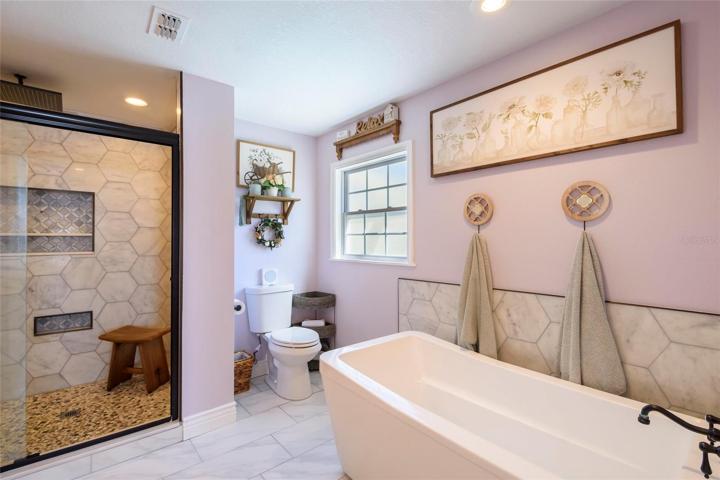 Master bathroom with glass shower and tub