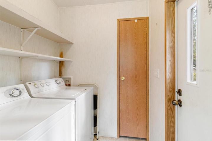 Inside laundry room and additional storage just inside the side door from the driveway